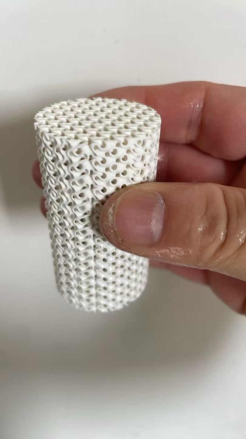  a custom porous YSZ zirconia ceramic disc with an interconnected open-cell structure.